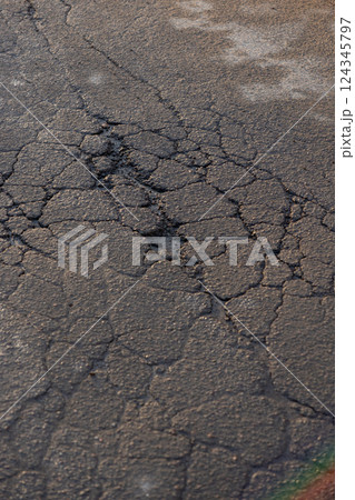 potholes in the road, holes in the asphalt on the roadway or highway. potholes in the road, holes in the asphalt on the roadway or highway. 124345797