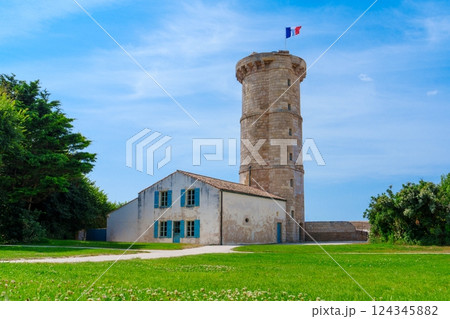 Historic Stone Watchtower with Proud French Flag Flying High Under Clear Blue Sky Historic Stone Watchtower with Proud French Flag Flying High Under Clear Blue Sky 124345882