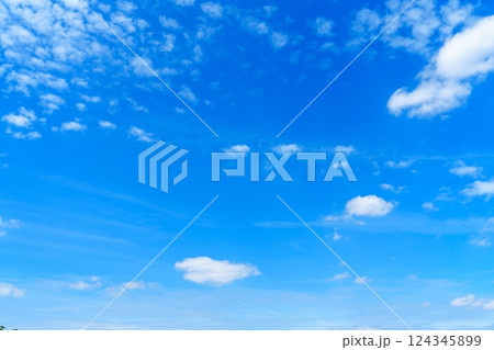 Vibrant Blue Sky with Fluffy White Clouds Creating a Serene and Peaceful Atmosphere in Nature Vibrant Blue Sky with Fluffy White Clouds Creating a Serene and Peaceful Atmosphere in Nature 124345899