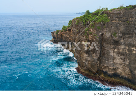 Cinematic aerial landscape shots of the beautiful island of Nusa Penida. Huge cliffs by the shoreline and hidden dream beaches with clear water and foaming wave. Cinematic aerial landscape shots of the beautiful island of Nusa Penida. Huge cliffs by the shoreline and hidden dream beaches with clear water and foaming wave. 124346043