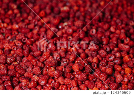 The background image. A large amount of raspberries with a blurred part and a place for text 124346609