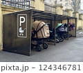 Covered parking, garage for baby carriages outdoors near residential building 124346781