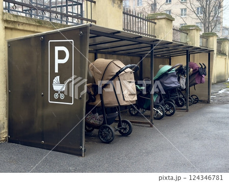 Covered parking, garage for baby carriages outdoors near residential building 124346781