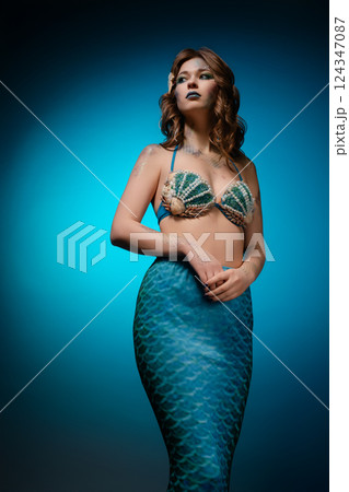 Mermaid cosplay with body art showcasing vibrant colors and intricate details Mermaid cosplay with body art showcasing vibrant colors and intricate details 124347087
