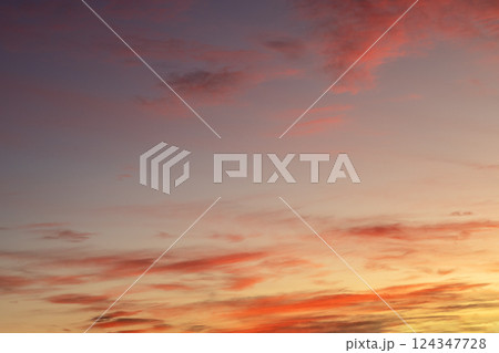 Colorful evening sky with vibrant orange and pink hues during sunset 124347728