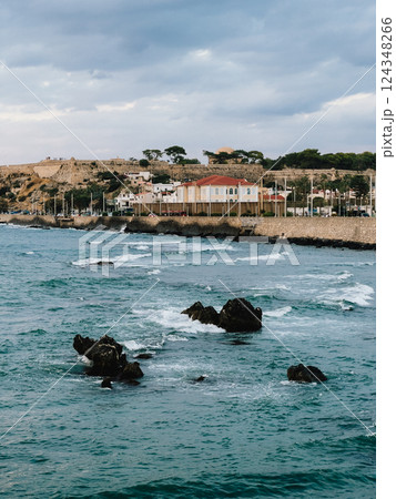 Venetian fortress of Rethymno, Crete, Greece, stands on hill overlooking mediterranean sea, with waves crashing against rocks and coastline. Panoramic view showing sea with rocks and waves crashing 124348266