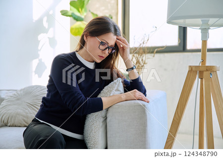 Mature sad woman experiencing stress, mental and physical pain, at home 124348790