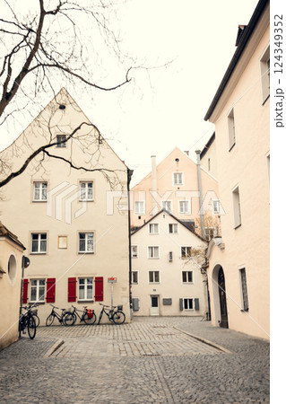 Quiet European courtyard with historic buildings and parked bicycles, evoking a nostalgic old-town 124349352
