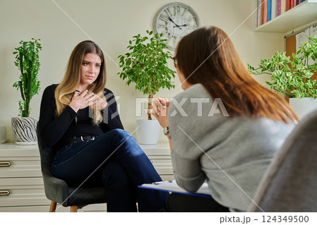 Sad unhappy young woman at therapy with female professional psychologist Sad unhappy young woman at therapy with female professional psychologist 124349500