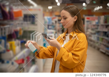 Searching for the perfect cosmetics in a beauty aisle at a store during daylight hours Searching for the perfect cosmetics in a beauty aisle at a store during daylight hours 124349776