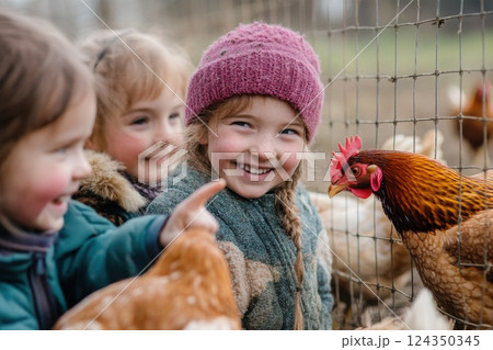 Happy children visiting a chicken coop on a farm 124350345