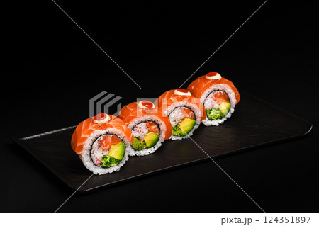 Delicious Fresh Salmon Sushi Rolls Presenting Exquisitely on a Black Background Delicious Fresh Salmon Sushi Rolls Presenting Exquisitely on a Black Background 124351897
