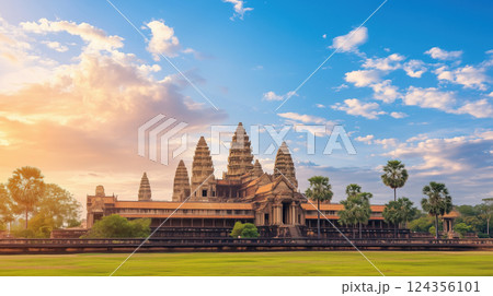 Ancient stone temple under vibrant sky, surrounded by lush greenery and palm trees 124356101