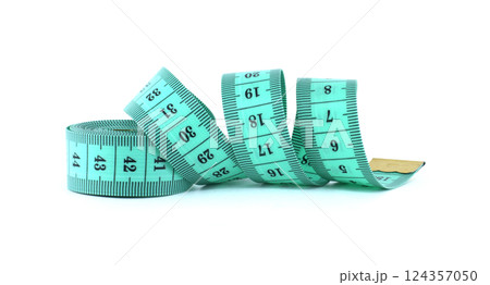 A light green measuring tape coiled on a white background, commonly used in sewing and tailoring. 124357050