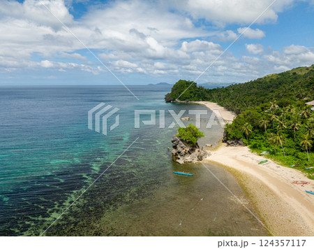 Boat floating over clear sea water. Beach with white sand in Santa Fe, Tablas, Romblon. Philippines. 124357117