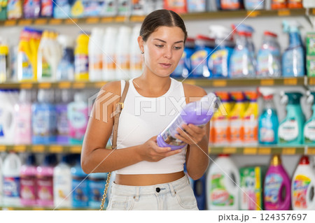 Young woman choosing detergent in store 124357697