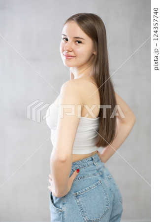 Young smiling woman posing in studio Young smiling woman posing in studio 124357740