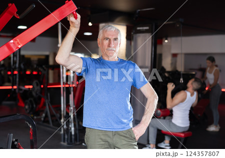 Elderly athletic man posing in gym 124357807