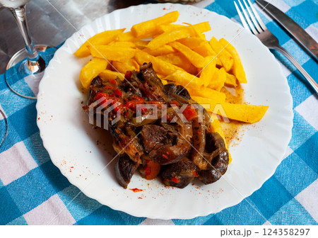 Lamb osso bucco with potatoes and vegetables on white plate 124358297