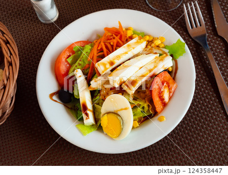 Salad of fresh tomatoes with cheese and eggs 124358447