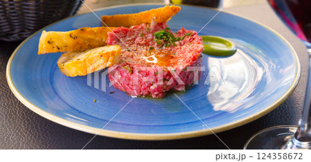 Image of delicious veal steak tartar served at plate with fried bread Image of delicious veal steak tartar served at plate with fried bread 124358672