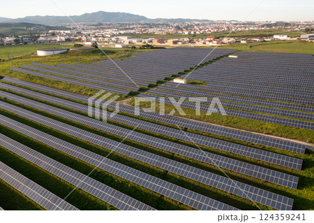 Solar panels in countryside field with townscape Solar panels in countryside field with townscape 124359241