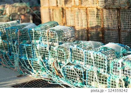 Stack of lobster traps on coastal waterfront 124359242