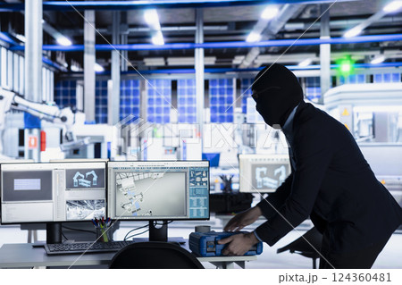 Masked man sneaking into solar panel plant at night to steal equipment, planning to sell it on black market. Thief in photovoltaics factory running with inventory gear, grabbing tool box Masked man sneaking into solar panel plant at night to steal equipment, planning to sell it on black market. Thief in photovoltaics factory running with inventory gear, grabbing tool box 124360481