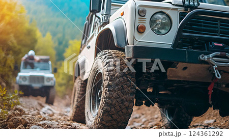 Adventurous Off-Road Vehicles Driving on Rocky Terrain in Majestic Mountain Landscape 124361292
