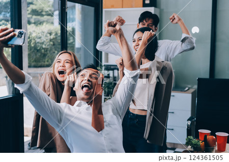 Asian office colleagues and friends enjoy a daytime BBQ with pizza and beer, celebrating Halloween and cheering for their favorite soccer team, creating a lively atmosphere filled with joy. Asian office colleagues and friends enjoy a daytime BBQ with pizza and beer, celebrating Halloween and cheering for their favorite soccer team, creating a lively atmosphere filled with joy. 124361505