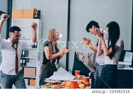 Asian office colleagues and friends enjoy a daytime BBQ with pizza and beer, celebrating Halloween and cheering for their favorite soccer team, creating a lively atmosphere filled with joy. Asian office colleagues and friends enjoy a daytime BBQ with pizza and beer, celebrating Halloween and cheering for their favorite soccer team, creating a lively atmosphere filled with joy. 124361518