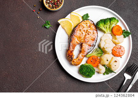 Roasted salmon fish steak with steamed vegetables Roasted salmon fish steak with steamed vegetables 124362804
