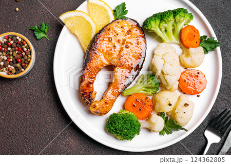 Grilled salmon fish steak with steamed vegetables Grilled salmon fish steak with steamed vegetables 124362805