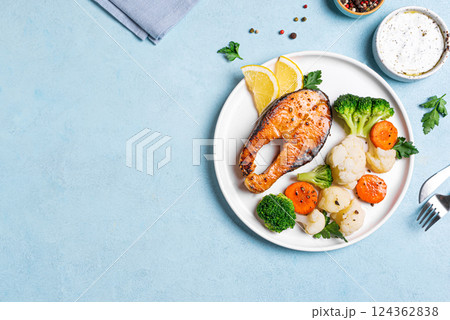 Roasted salmon fish steak with steamed vegetables 124362838