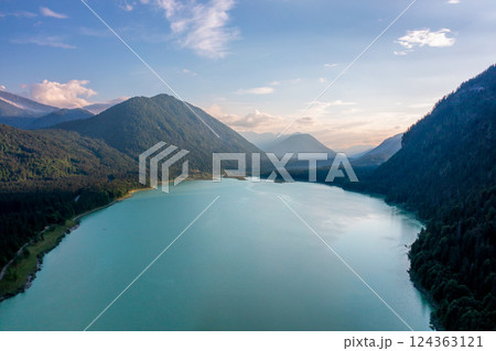 Drone image at sunset with Lake Sylvenstein surrounded by mountains in the Upper Bavaria region, Germany 124363121
