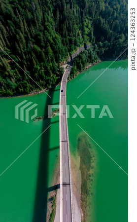 Drone aerial view at sunrise with the bridge over Sylvenstein Lake in Upper Bavaria, Germany 124363253