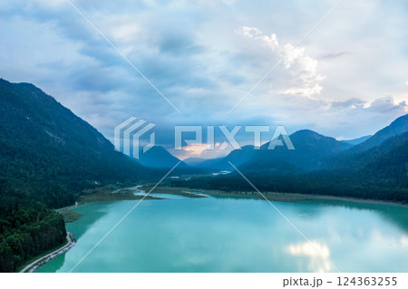Drone aerial view at sunset with Lake Sylvenstein surrounded by Bavarian Alps, in Germany Drone aerial view at sunset with Lake Sylvenstein surrounded by Bavarian Alps, in Germany 124363255