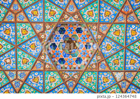 beautiful carved wooden painted ceiling in palace in Museum of Art of Uzbekistan with traditional Uzbek ornaments and colorful oriental patterns in Tashkent 124364748