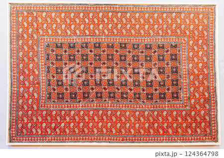 oriental Uzbek carpet with a traditional abstract geometric pattern. Vintage handmade Turkish carpet on white isolated background 124364798