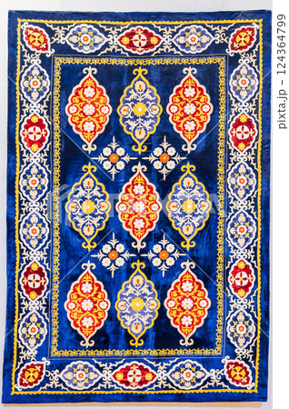 traditional Uzbek geometric pattern on ancient handmade carpet in Uzbekistan. Oriental background with beautiful ornaments 124364799