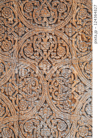 traditional Uzbek carved pattern kandakori on vintage wooden door in Tashkent in Uzbekistan closeup traditional Uzbek carved pattern kandakori on vintage wooden door in Tashkent in Uzbekistan closeup 124364827