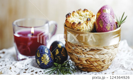 Close up Easter still life. Small wicker basket of bright Easter eggs, bread, candle on lace napkin. Close up Easter still life. Small wicker basket of bright Easter eggs, bread, candle on lace napkin. 124364926