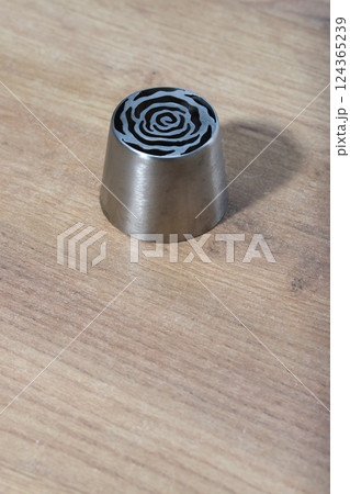 Tip for making marshmallow tulips. Pastry tip made of metal. Close-up view. Tip for making marshmallow tulips. Pastry tip made of metal. Close-up view. 124365239