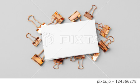 Blank business card mockup on copper binder paper clips on grey background 124366279