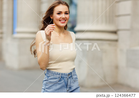 Portrait of young woman traveler tourist on city street. 124366477