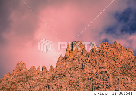 Mountain landscape in the evening. The Dolomites Alps against the sunset sky. Sella Pass, Grohmannspitze, Selva di Val Gardena, Bolzano, Italy 124366541