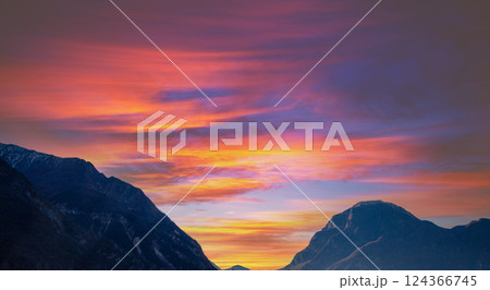 Beautiful mountains against sunset sky.  Silhouette of mountains peaks during sunset 124366745