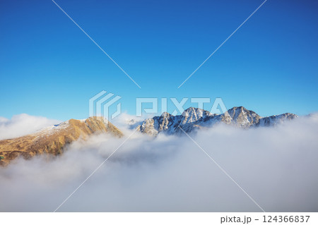 Mountains minimalist landscape. Peaks of the mountains above the clouds. Pyrenees, Andorra, Europe Mountains minimalist landscape. Peaks of the mountains above the clouds. Pyrenees, Andorra, Europe 124366837