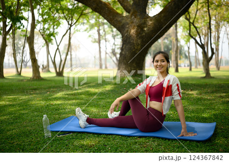 Young woman practicing yoga practicing yoga in nature, sitting in Half lord of the fishes pose Young woman practicing yoga practicing yoga in nature, sitting in Half lord of the fishes pose 124367842