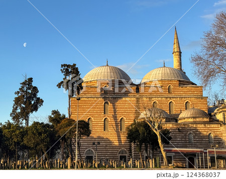 Historic Ottoman Sinan Pasha Mosque with a Crescent Moon Under Clear Blue Skies at Sunset 124368037